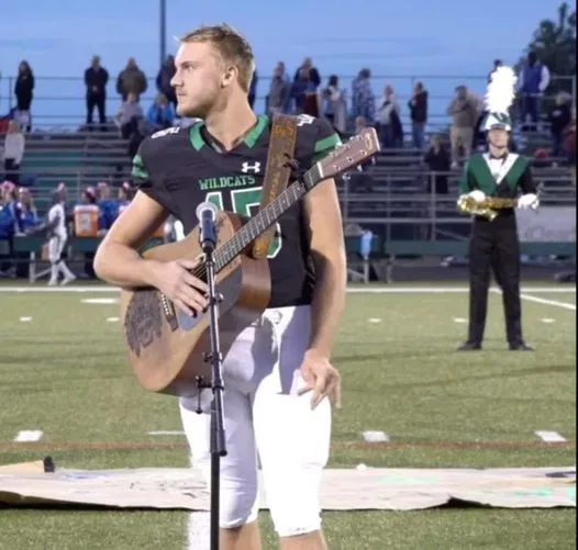 No one was willing to sing the national anthem, so one high schooler took off his helmet and grabbed a guitar.