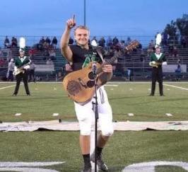 No one wanted to sing the national anthem, so one high school student took off his helmet and grabbed up a guitar.