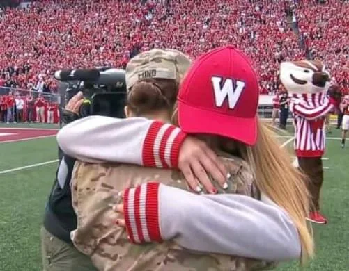 Soldier mom returns to surprise daughter at a Wisconsin football game