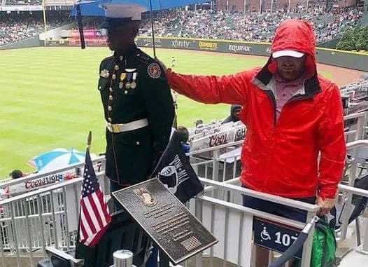 Baseball Fan Holding Umbrella Over JROTC Member On Memorial Day